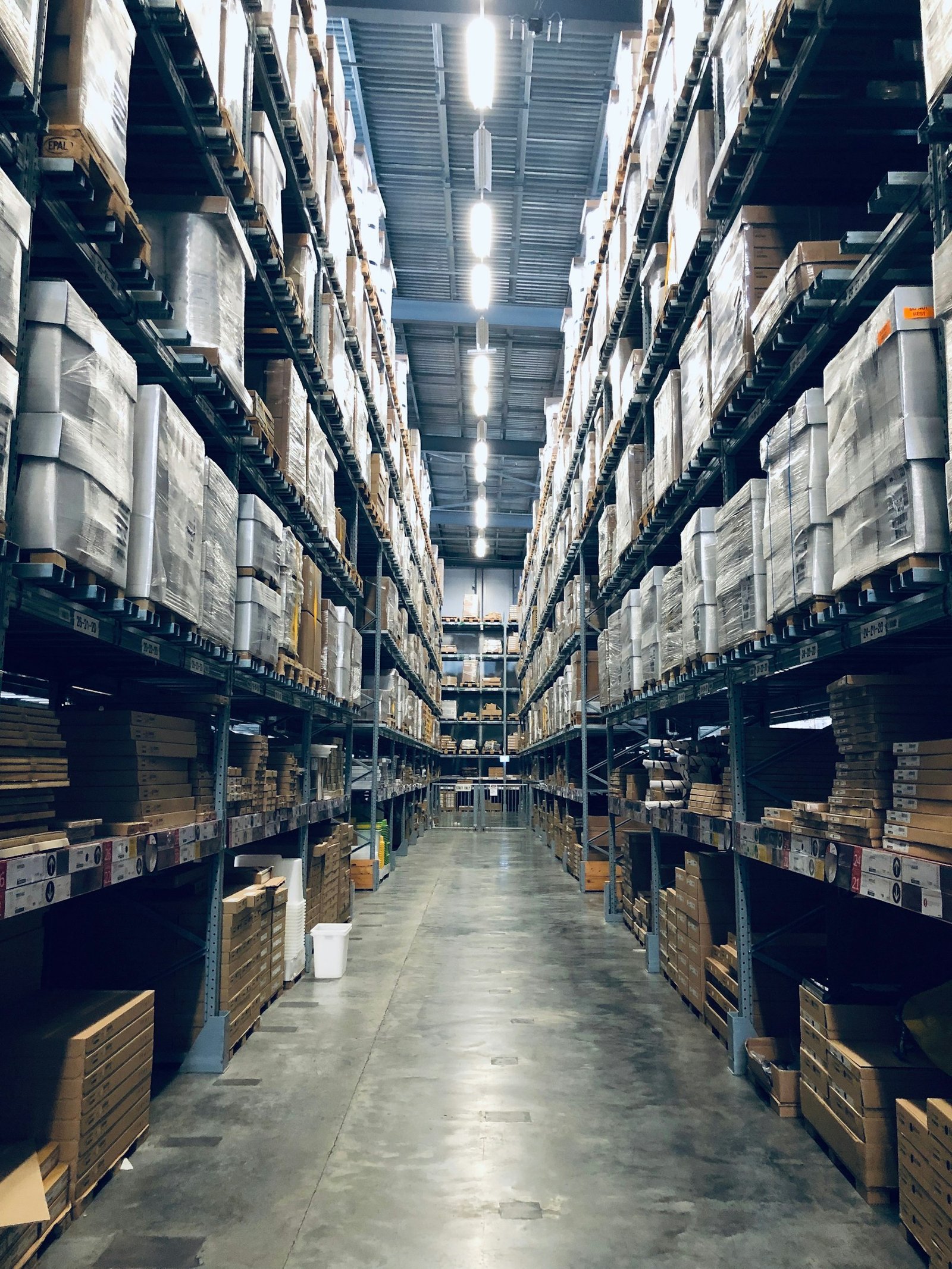 Narrow warehouse aisle between pallet racking